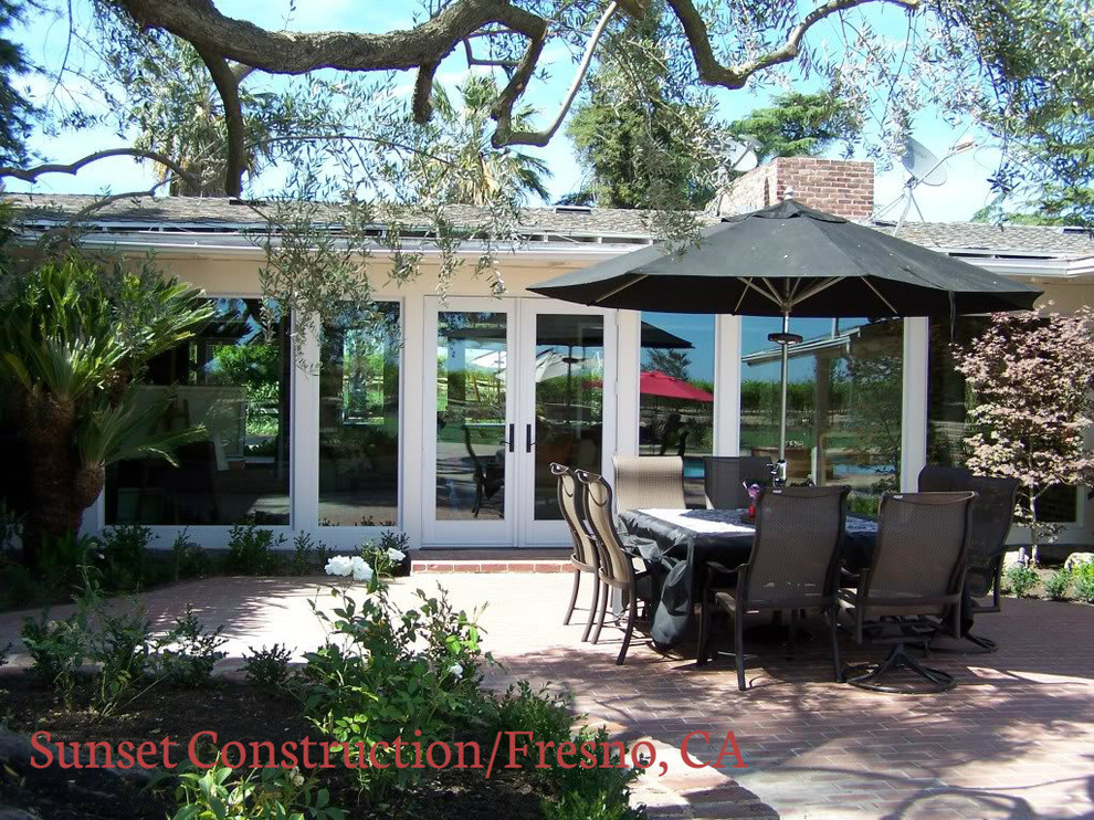 Design ideas for a large arts and crafts backyard patio in Other with concrete slab and a roof extension.