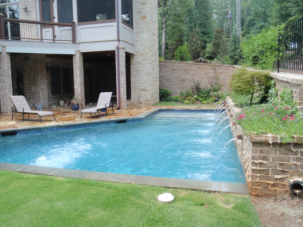 Inspiration for a transitional backyard custom-shaped and stone pool fountain remodel in Atlanta