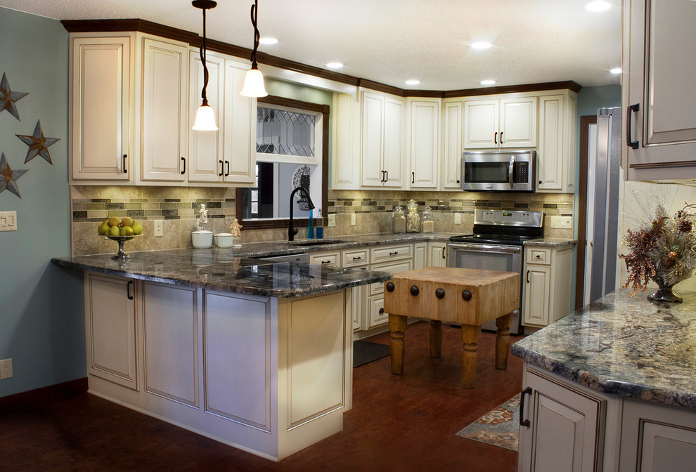 Mid-sized elegant u-shaped dark wood floor and brown floor kitchen photo with an undermount sink, raised-panel cabinets, white cabinets, granite countertops, beige backsplash, ceramic backsplash, stainless steel appliances and an island