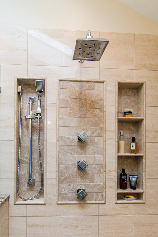 This is an example of a mid-sized traditional master bathroom in Philadelphia with raised-panel cabinets, brown cabinets, a corner shower, a two-piece toilet, beige tile, stone tile, beige walls, marble floors, an undermount sink and granite benchtops.