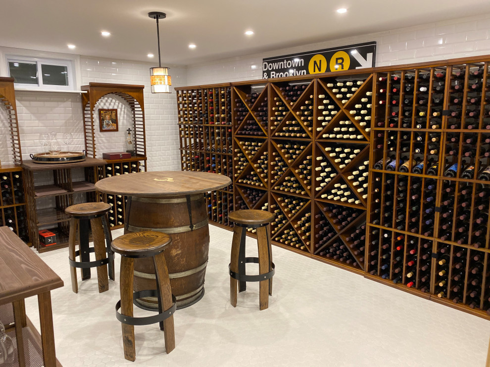 Photo of a large contemporary wine cellar in New York with storage racks and white floor.