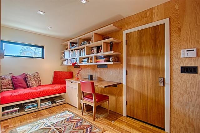 Example of a mid-sized trendy built-in desk light wood floor and beige floor study room design in San Francisco with brown walls and no fireplace