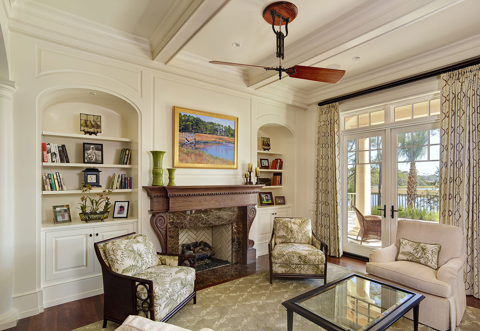 Inspiration for a traditional enclosed living room in Charleston with a library and a standard fireplace.