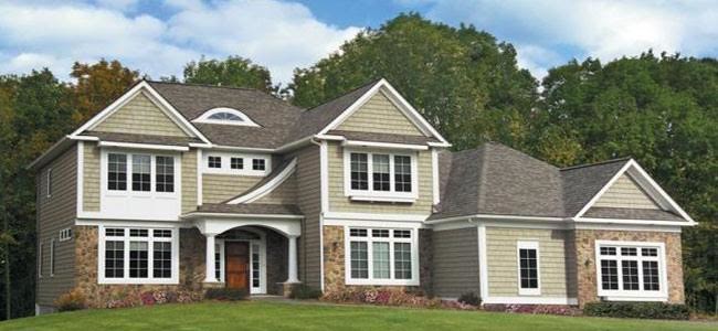 Large transitional green two-story mixed siding exterior home idea in Austin with a hip roof