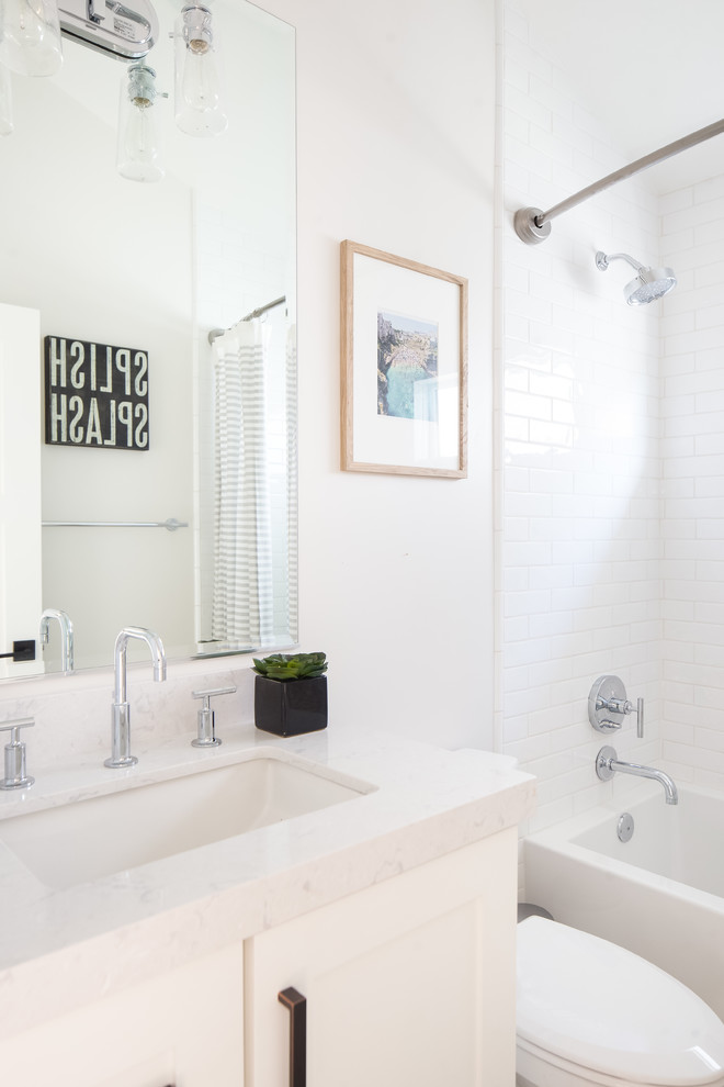 Inspiration for a small transitional 3/4 bathroom in Orange County with shaker cabinets, white cabinets, an alcove shower, a two-piece toilet, white tile, ceramic tile, white walls, linoleum floors, an undermount sink, solid surface benchtops, turquoise floor and a hinged shower door.