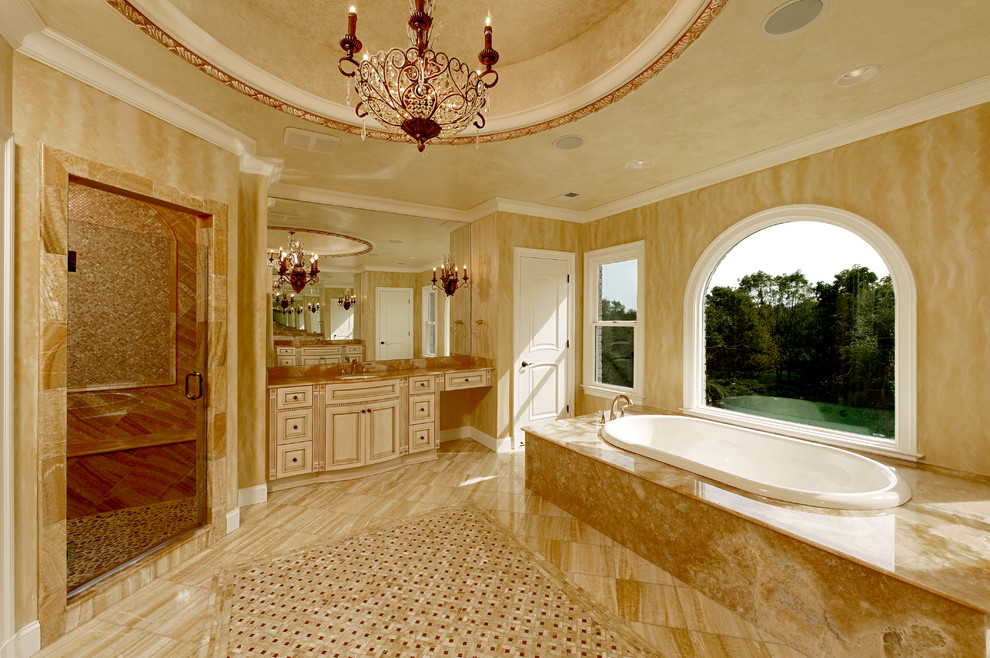 Design ideas for a large mediterranean master bathroom in DC Metro with beige floor, raised-panel cabinets, beige cabinets, a drop-in tub, a corner shower, brown tile, mosaic tile, beige walls, porcelain floors, an undermount sink, granite benchtops and a hinged shower door.