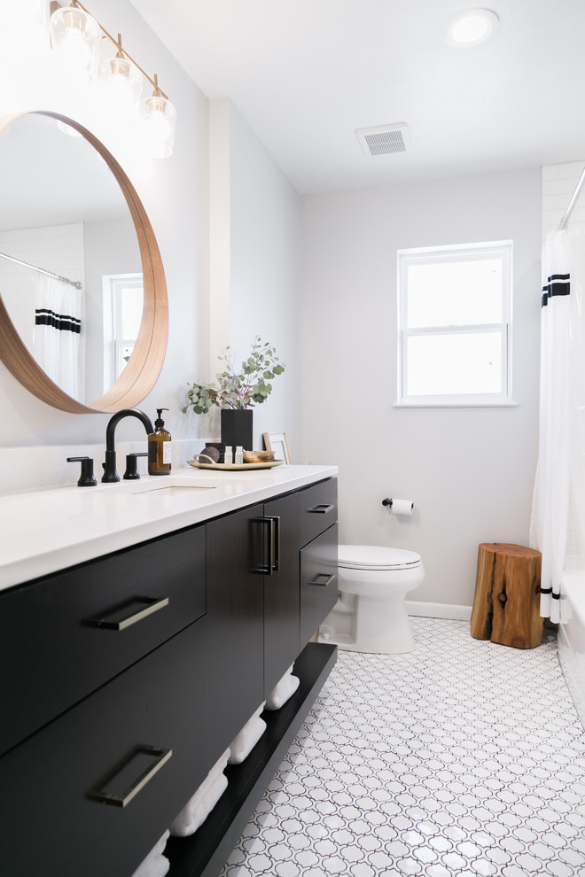 This is an example of a contemporary 3/4 bathroom in Dallas with flat-panel cabinets, black cabinets, white walls, an undermount sink, white floor and white benchtops.