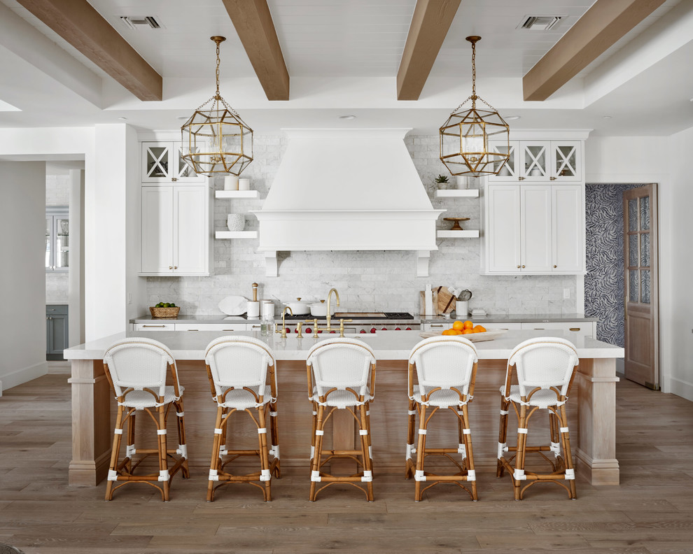 Photo of a large country kitchen in Phoenix with a farmhouse sink, white cabinets, quartz benchtops, marble splashback, light hardwood floors, with island, beige floor, grey benchtop, shaker cabinets, white splashback and stainless steel appliances.