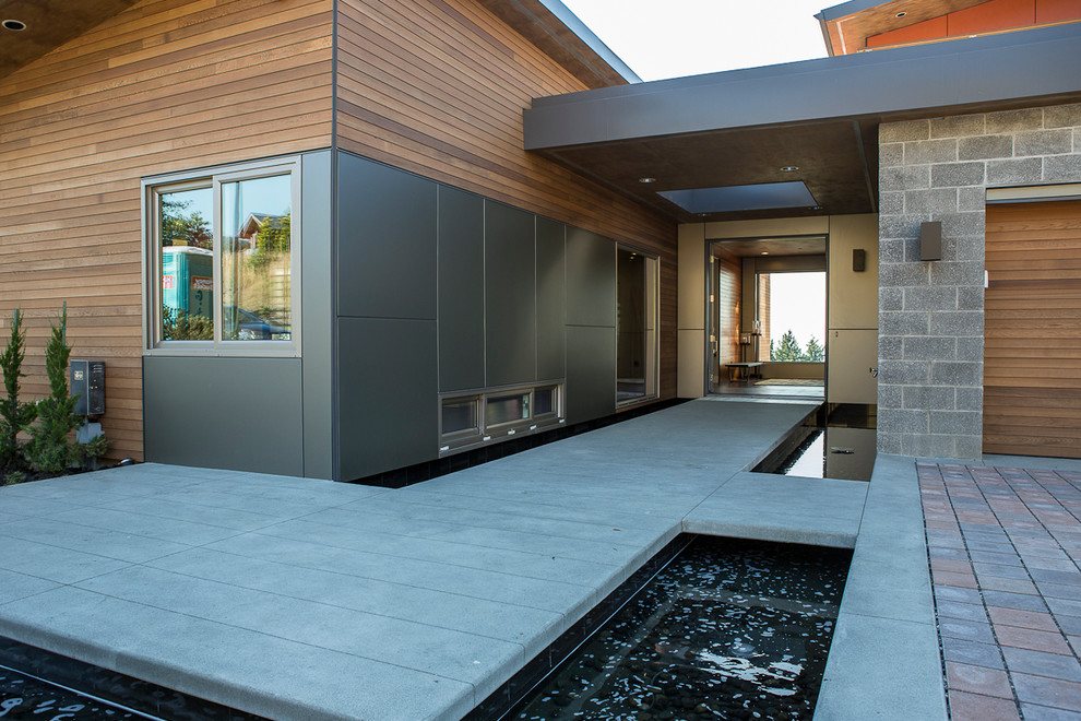 Example of a trendy concrete floor entryway design in Seattle