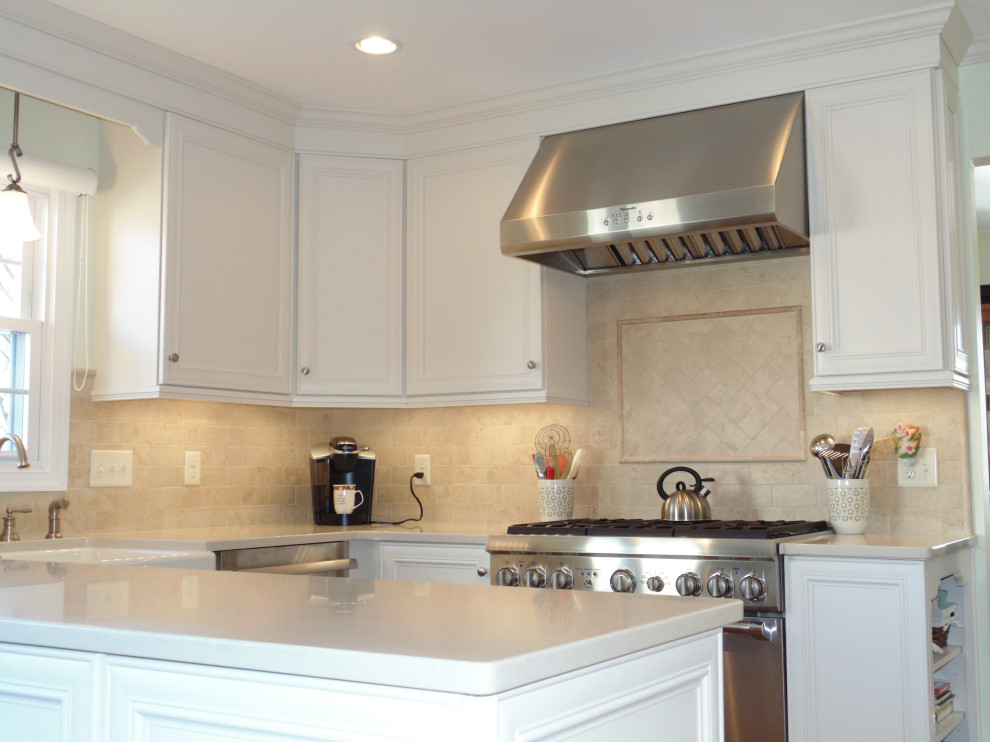 Large transitional u-shaped medium tone wood floor and brown floor eat-in kitchen photo with a farmhouse sink, flat-panel cabinets, white cabinets, quartz countertops, beige backsplash, travertine backsplash, stainless steel appliances and beige countertops
