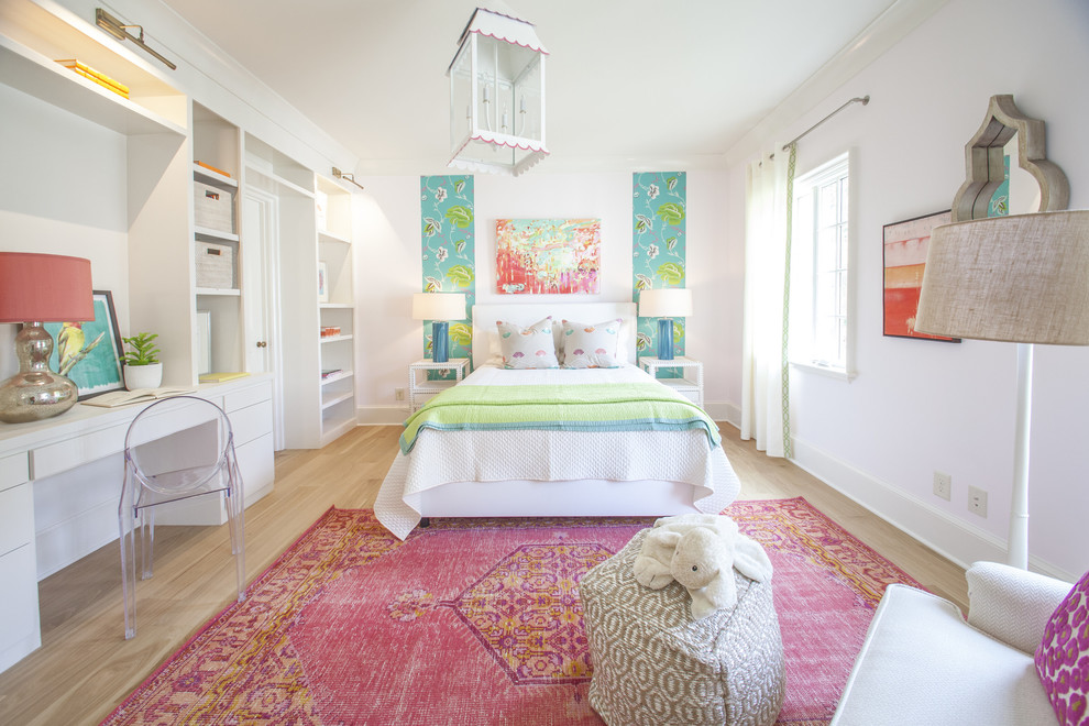 Transitional kids' room in Charlotte with white walls and light hardwood floors for girls.