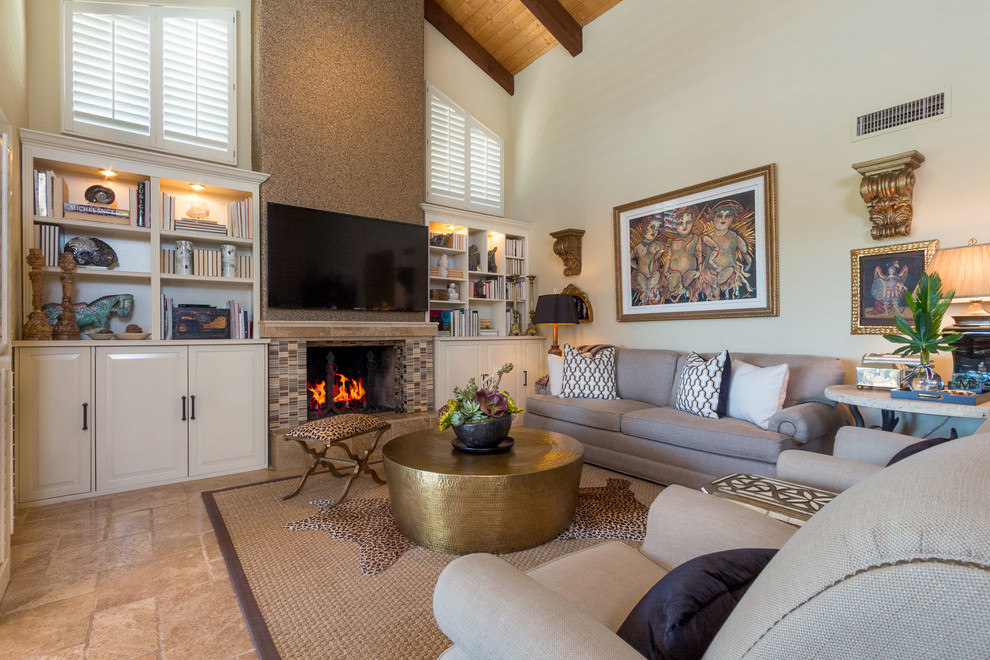 Design ideas for a mid-sized transitional open concept family room in Phoenix with beige walls, travertine floors, a standard fireplace, a tile fireplace surround and a wall-mounted tv.