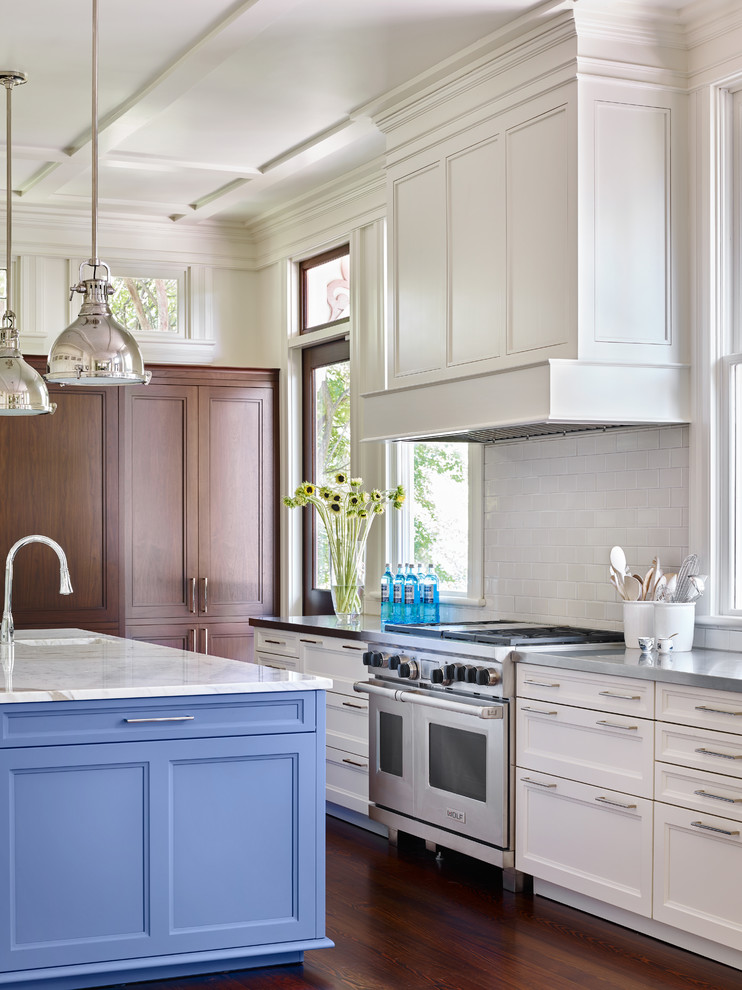 Inspiration for a large traditional eat-in kitchen in Atlanta with recessed-panel cabinets, white splashback, ceramic splashback, stainless steel appliances, with island, white cabinets, dark hardwood floors and brown floor.