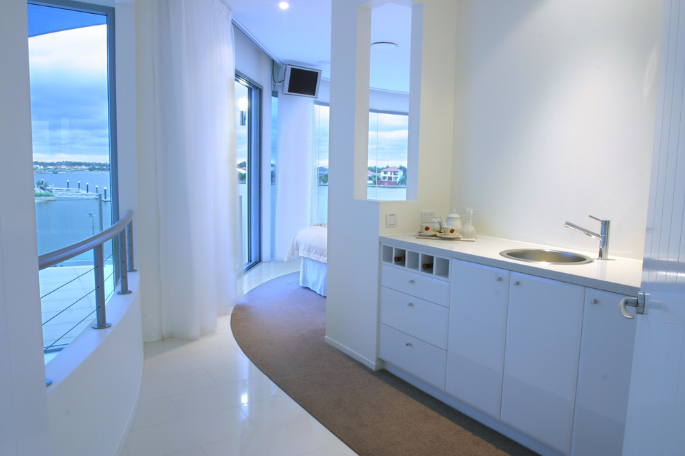 Expansive contemporary master bedroom in Sunshine Coast with white walls and ceramic floors.