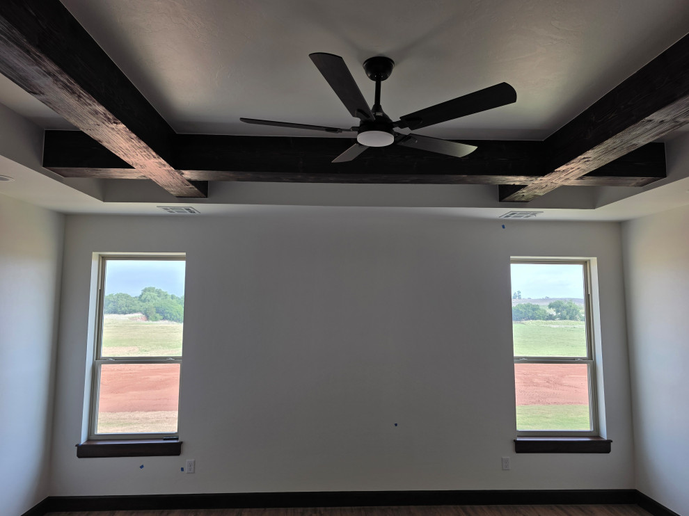 Trey ceilings with massive wood beams & large windows enrich the Primary/Master 