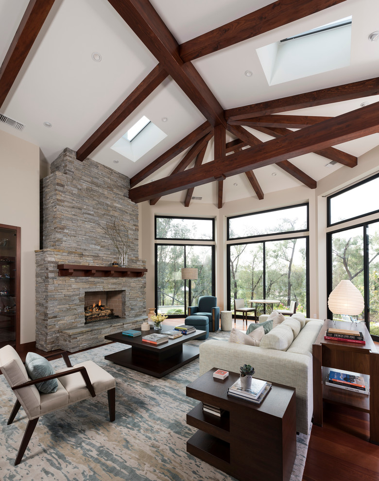 Inspiration for a large transitional formal open concept living room in San Diego with white walls, medium hardwood floors, a standard fireplace, a stone fireplace surround, no tv and brown floor.