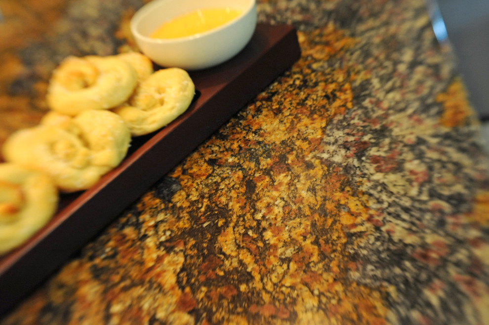 Inspiration for a mid-sized transitional u-shaped limestone floor and beige floor eat-in kitchen remodel in Cincinnati with a double-bowl sink, shaker cabinets, medium tone wood cabinets, granite countertops, beige backsplash, ceramic backsplash, stainless steel appliances and a peninsula