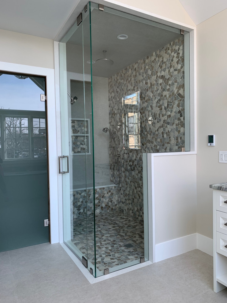 Photo of a large eclectic master bathroom in Chicago with furniture-like cabinets, white cabinets, an undermount tub, an open shower, a one-piece toilet, gray tile, pebble tile, grey walls, ceramic floors, an undermount sink, quartzite benchtops, grey floor, a hinged shower door, grey benchtops, an enclosed toilet, a single vanity, a freestanding vanity and vaulted.