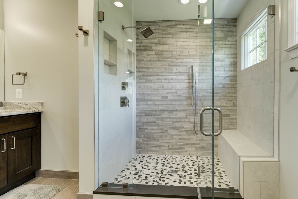 Inspiration for a large transitional master bathroom in DC Metro with shaker cabinets, dark wood cabinets, an alcove shower, beige tile, mosaic tile, beige walls, laminate floors, an undermount sink, engineered quartz benchtops, beige floor and a hinged shower door.
