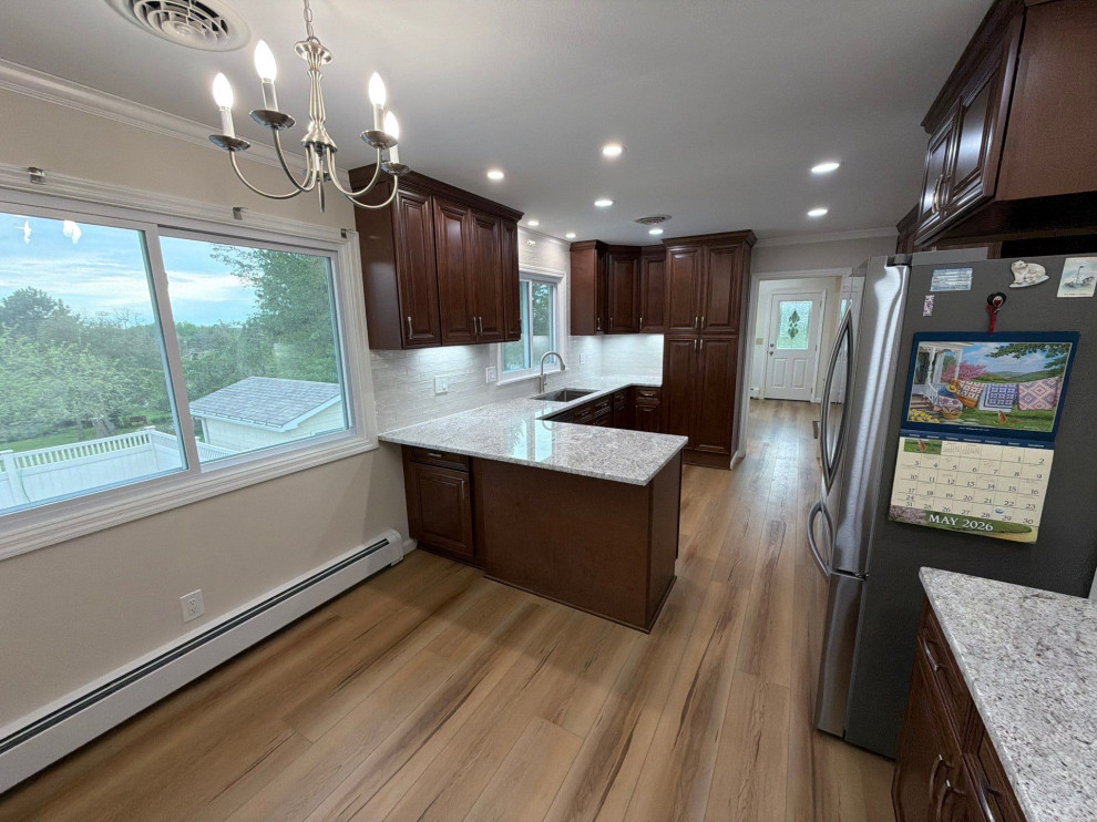 USCD cabinetry accompanied granite countertops, porcelain tile backsplash and Ca