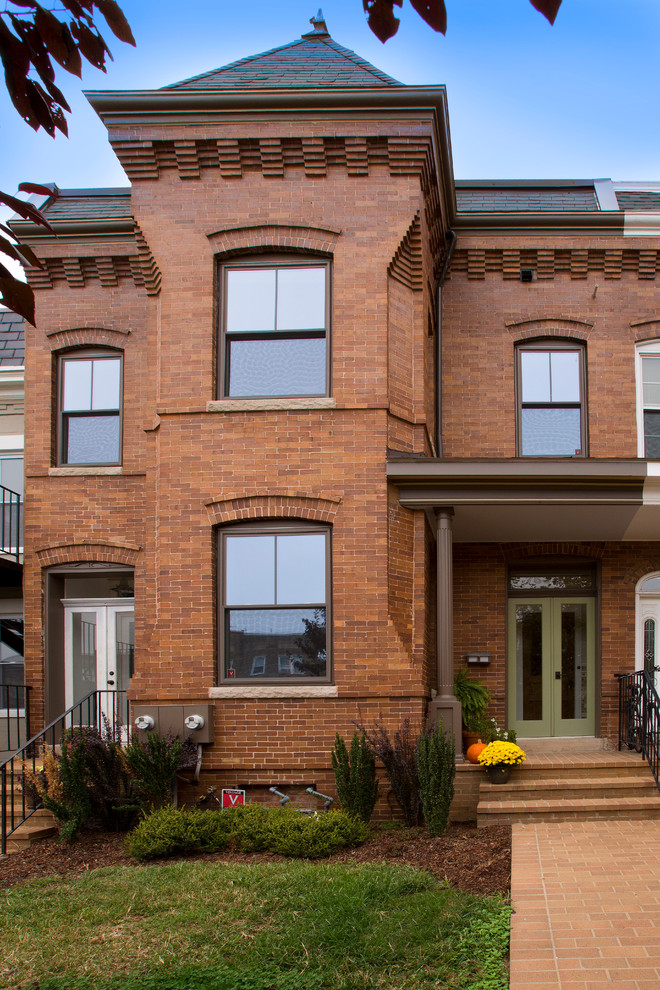 Photo of a mid-sized traditional two-storey brick red exterior in DC Metro with a gable roof.