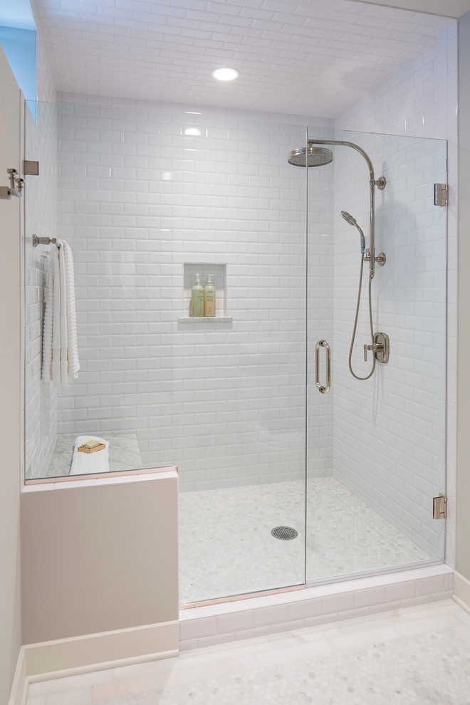 Traditional bathroom in Minneapolis with an alcove shower, white tile, subway tile and a hinged shower door.