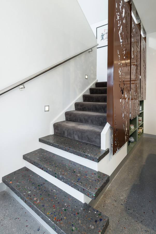 Inspiration for a mid-sized modern carpeted u-shaped staircase in Adelaide with concrete risers and metal railing.