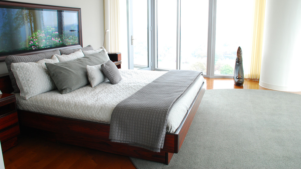 Bedroom - large contemporary master medium tone wood floor bedroom idea in Atlanta with gray walls