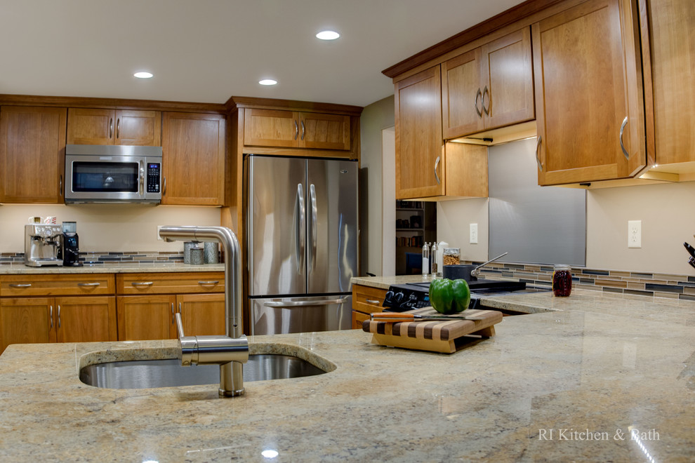 Example of a mid-sized transitional u-shaped porcelain tile enclosed kitchen design in Providence with an undermount sink, shaker cabinets, medium tone wood cabinets, granite countertops, multicolored backsplash, glass tile backsplash, stainless steel appliances and no island
