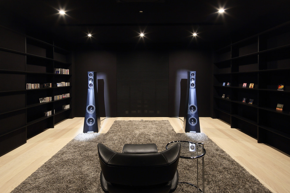 Photo of a contemporary enclosed home theatre in Kyoto with black walls, beige floor and light hardwood floors.