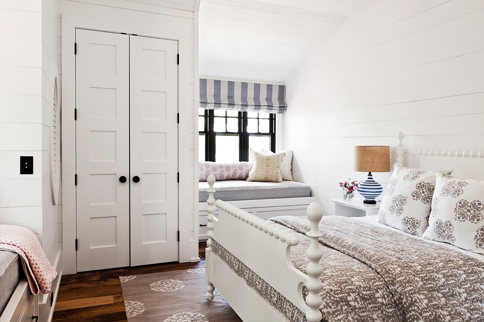 Photo of a beach style master bedroom in Toronto with white walls, medium hardwood floors and orange floor.