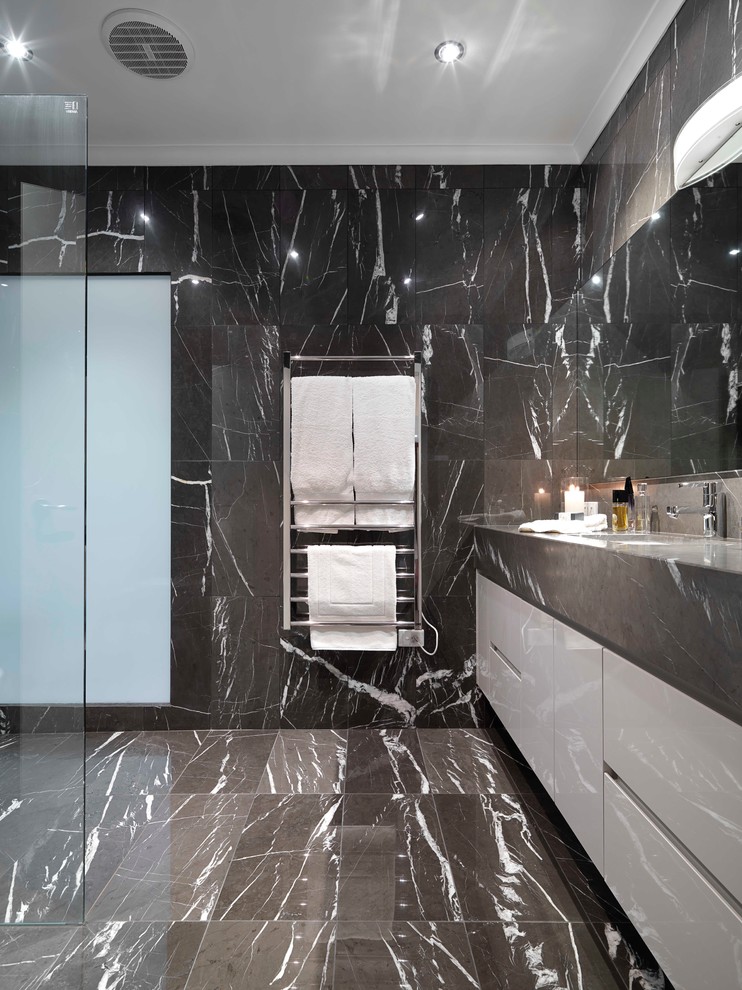 Mid-sized contemporary master bathroom in Melbourne with an undermount sink, flat-panel cabinets, black cabinets, marble benchtops, an open shower, a wall-mount toilet, black tile, stone tile, black walls and marble floors.