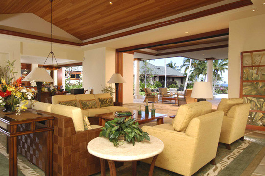 Photo of a mid-sized tropical open concept living room in Hawaii with yellow walls and no tv.