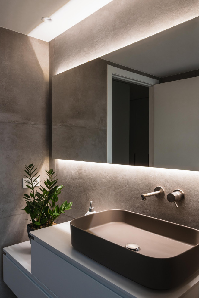 Design ideas for a mid-sized modern master wet room bathroom in Valencia with furniture-like cabinets, grey cabinets, a one-piece toilet, gray tile, ceramic tile, grey walls, ceramic floors, a vessel sink, grey floor, a sliding shower screen, an enclosed toilet, a single vanity and a built-in vanity.