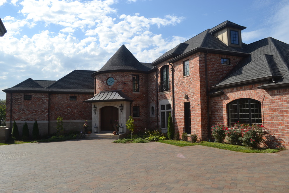 Large traditional two-storey brick red exterior in St Louis with a hip roof.