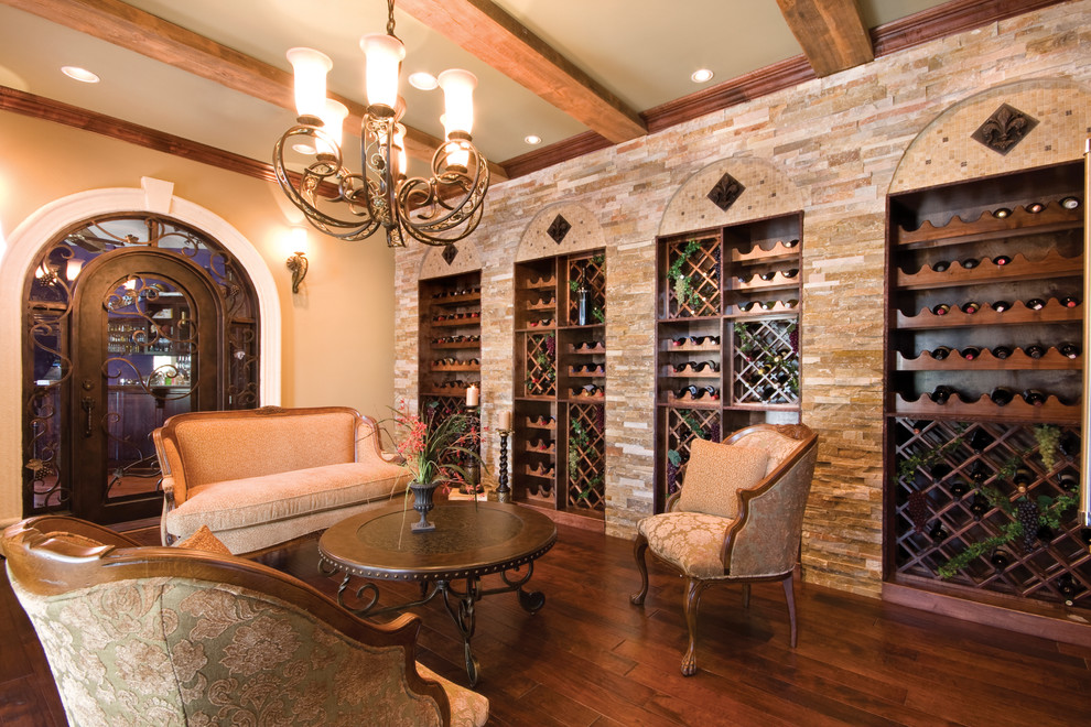Mediterranean wine cellar in New Orleans with dark hardwood floors and diamond bins.