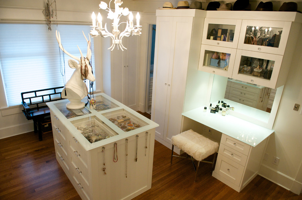 Photo of a large eclectic dressing room in Vancouver with white cabinets, medium hardwood floors, brown floor and vaulted.