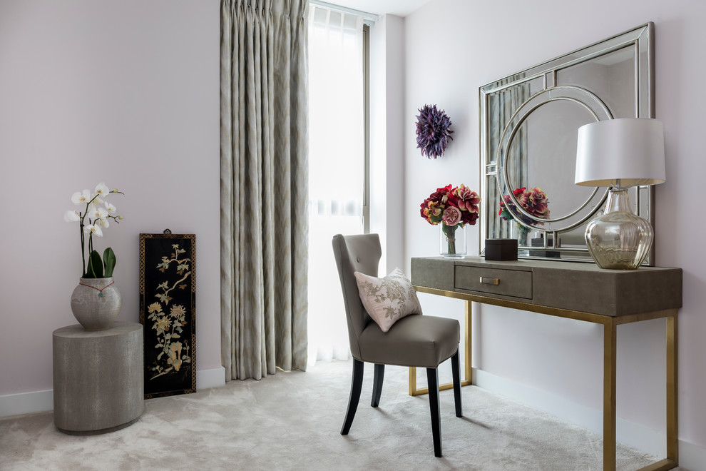Mid-sized transitional master bedroom in London with pink walls and carpet.
