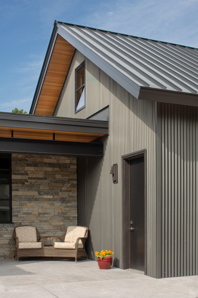 Photo of an expansive modern two-storey house exterior in Other with metal siding and a mixed roof.