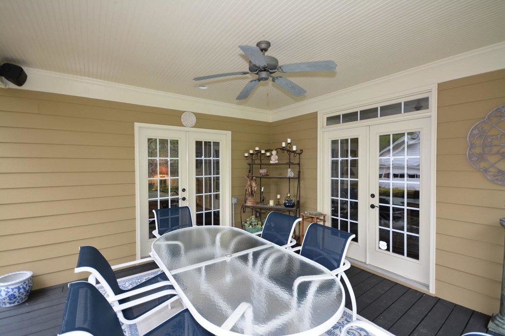 Example of a mid-sized transitional backyard deck design in Atlanta with a roof extension