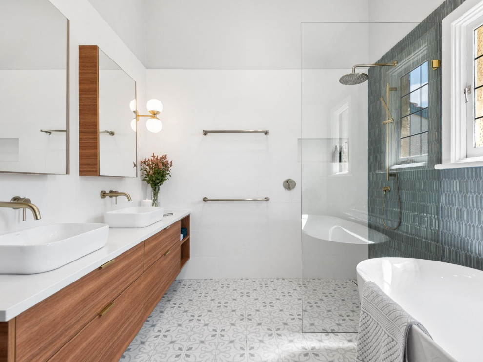 Inspiration for a large contemporary master bathroom in Perth with flat-panel cabinets, a freestanding tub, a corner shower, solid surface benchtops, an open shower, white benchtops, a double vanity, medium wood cabinets, gray tile, white walls, grey floor, a niche and a floating vanity.