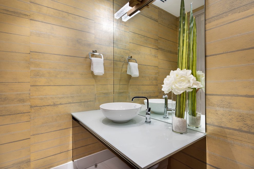 Design ideas for a contemporary powder room in Miami with brown walls, a vessel sink and white benchtops.