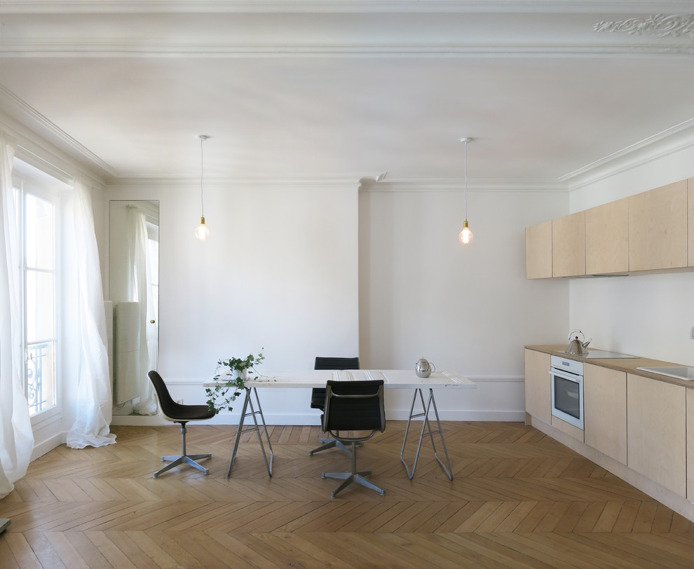 Design ideas for a mid-sized scandinavian single-wall eat-in kitchen in Paris with no island and light wood cabinets.