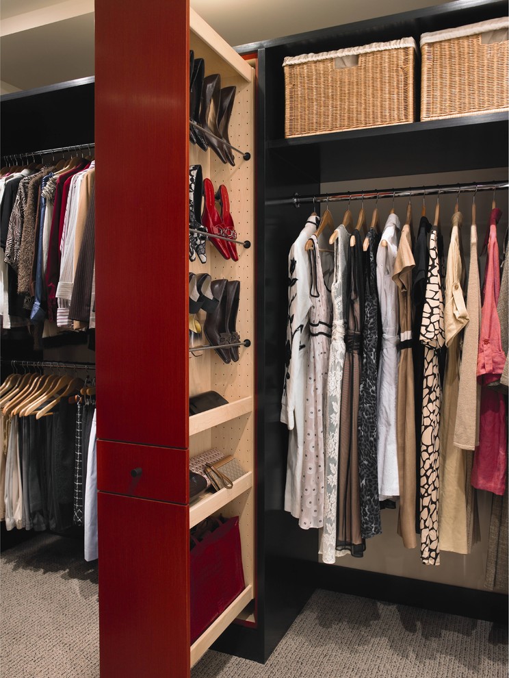 This is an example of a large contemporary gender-neutral walk-in wardrobe in Houston with flat-panel cabinets, red cabinets, carpet and beige floor.