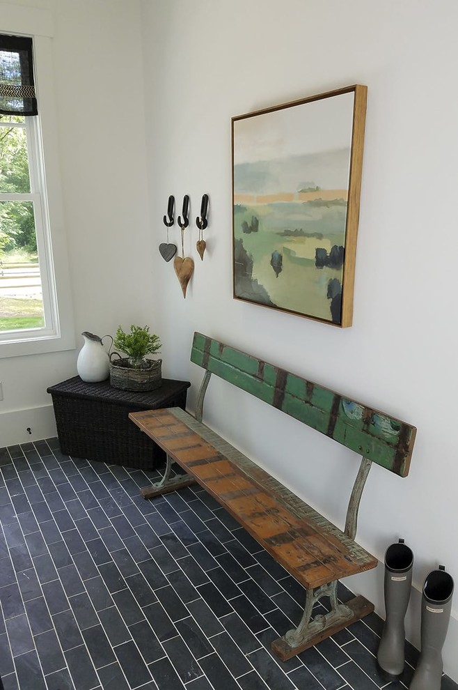 Inspiration for a country mudroom in Atlanta with white walls, ceramic floors and black floor.