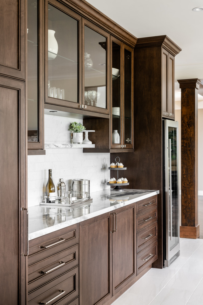 Large transitional u-shaped porcelain tile and white floor open concept kitchen photo in Vancouver with an undermount sink, recessed-panel cabinets, dark wood cabinets, quartz countertops, white backsplash, ceramic backsplash, stainless steel appliances, an island and white countertops