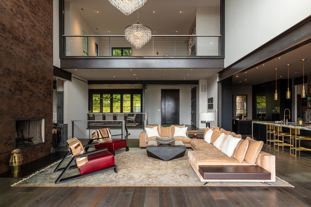 Inspiration for a large contemporary open concept living room in Other with beige walls, dark hardwood floors, a standard fireplace, a metal fireplace surround and brown floor.