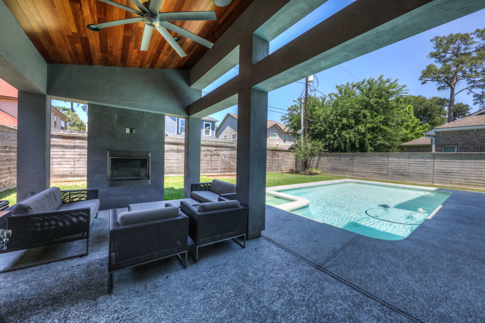 Mid-sized contemporary backyard rectangular lap pool in Houston with a hot tub and concrete pavers.