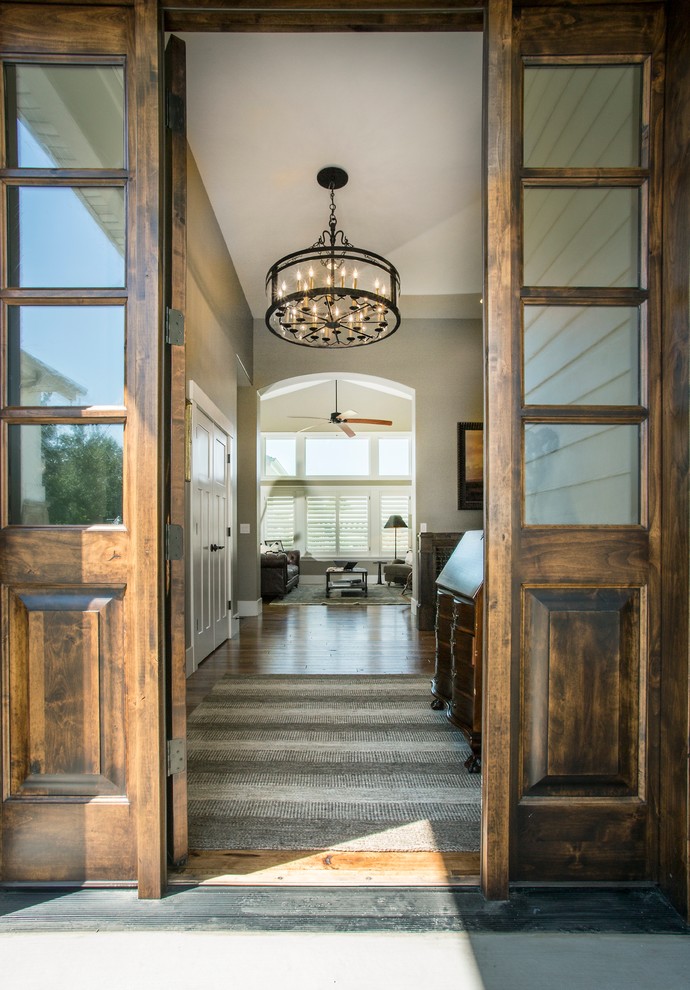 Mid-sized country front door in Salt Lake City with grey walls, medium hardwood floors, a single front door, a dark wood front door and brown floor.