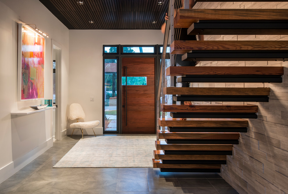 This is an example of a large contemporary hallway in Miami with white walls and porcelain floors.
